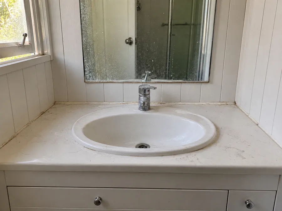 Marked bathroom vanity before a professional bond clean in Brisbane