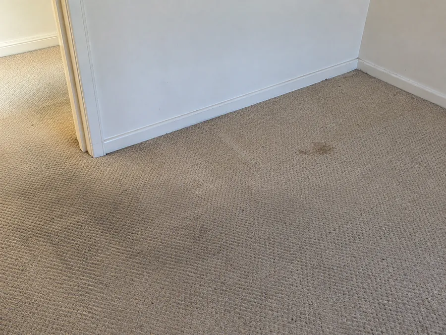 Stained bedroom carpet before an end of lease steam clean