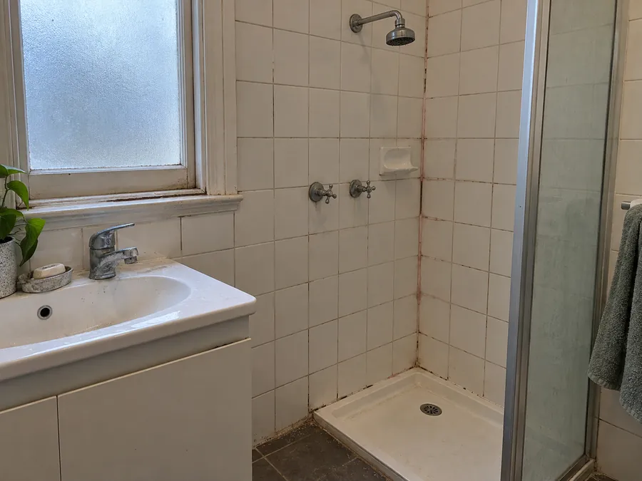 Marked bathroom tiles and grout before an end of lease clean in Melbourne