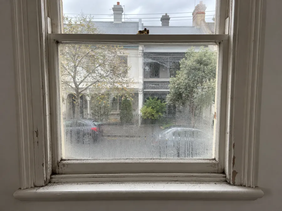 Grimy sash window and sill before an end of lease clean in Melbourne