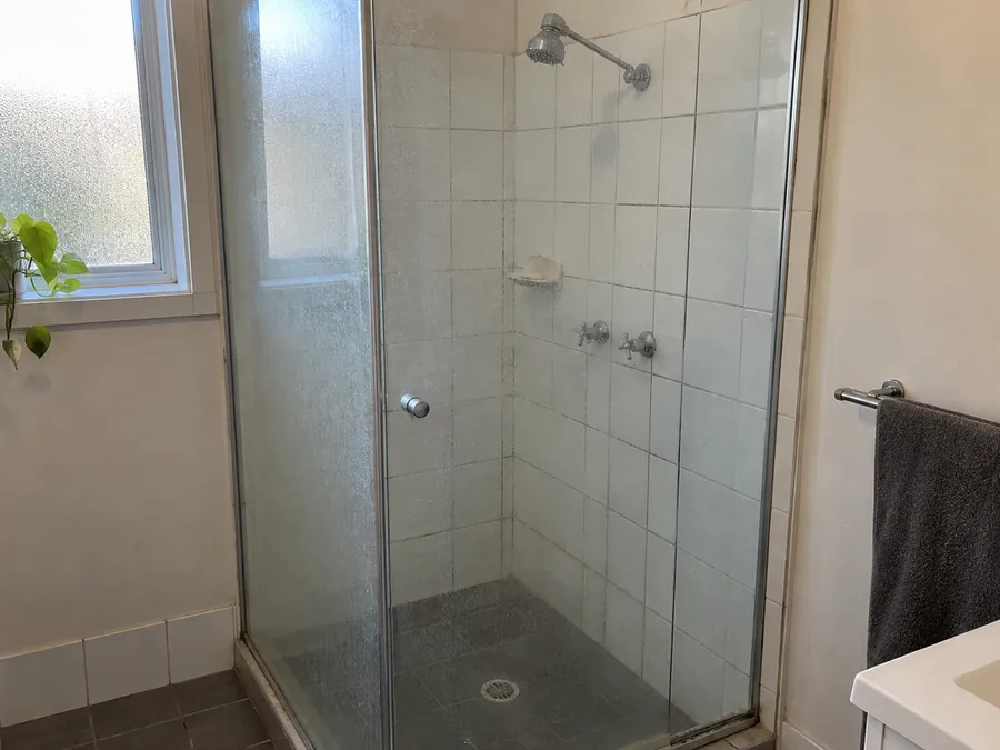 Soap marked shower screen and grout before an end of lease clean