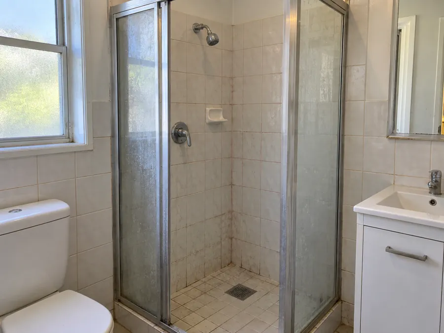 Soap marked shower screen before an end of lease clean in Sydney