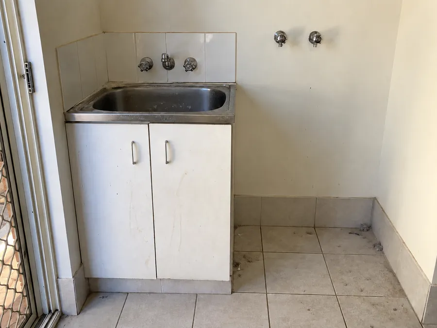 Dirty rental laundry sink and floor before a Perth vacate clean